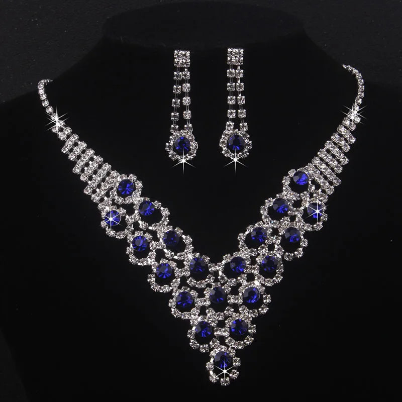 High end and elegant bridal accessories, including a necklace and a pair of earrings, set in blue, red, and purple. Bridal acces