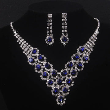 High end and elegant bridal accessories, including a necklace and a pair of earrings, set in blue, red, and purple. Bridal acces